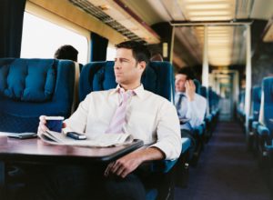 Businessman With a Cup of Coffee on a Passenger Train